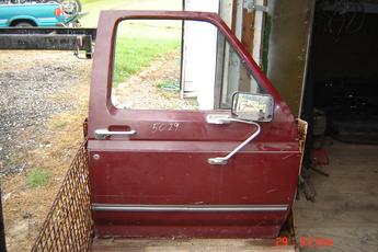 1980 1981 1982 1983 1984 1985 1986 Ford Right Side OEM door.  Door has a small dent near the body line, glass broke on mirror, dent on chrome back of mirror.  Burgundy exterior.